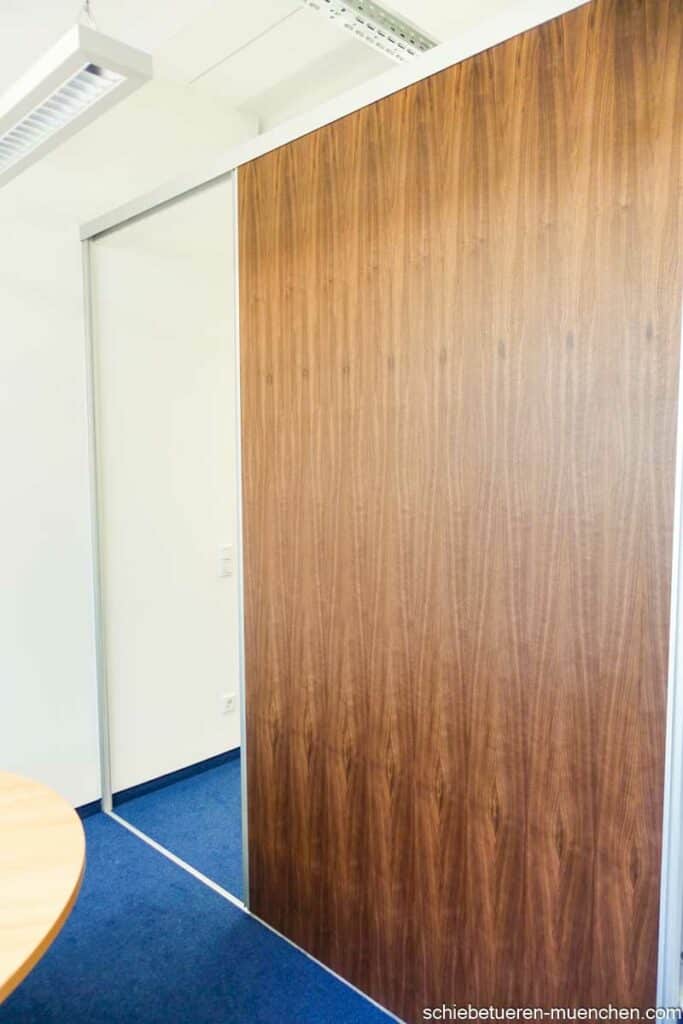 Raumteiler in einem Konferenzraum mit einer Nussbaum holz Schiebetüre in München