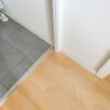 Weiße Anschlagleiste des Raumteilers zwischen Flur und Wohnzimmer aus Klarglas mit Sprossen – hängende Schiebetüren München.